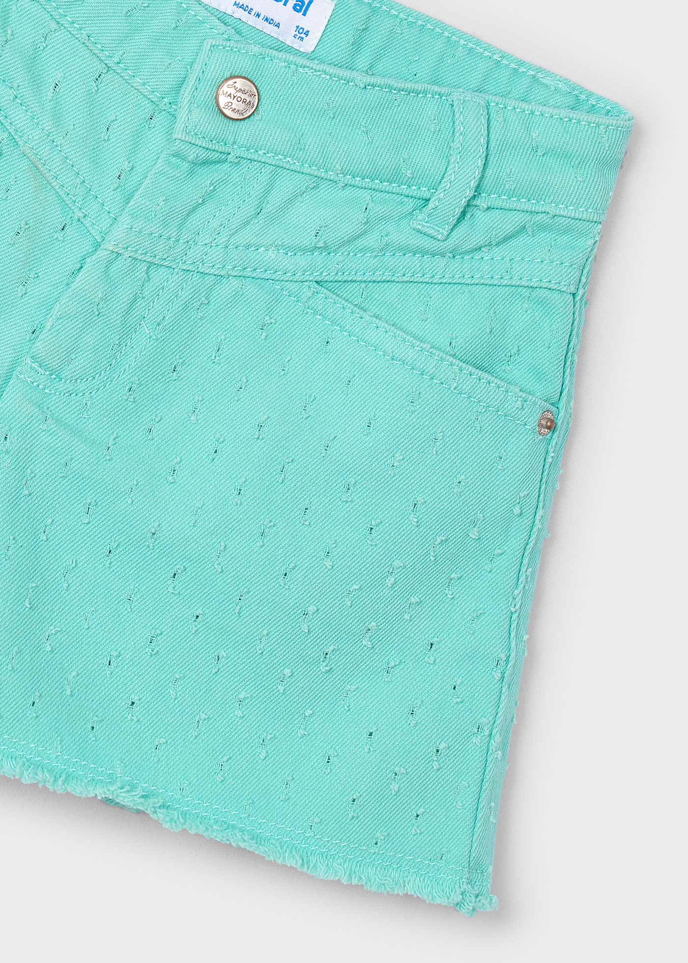 Pantalón corto bajo desflecado niña