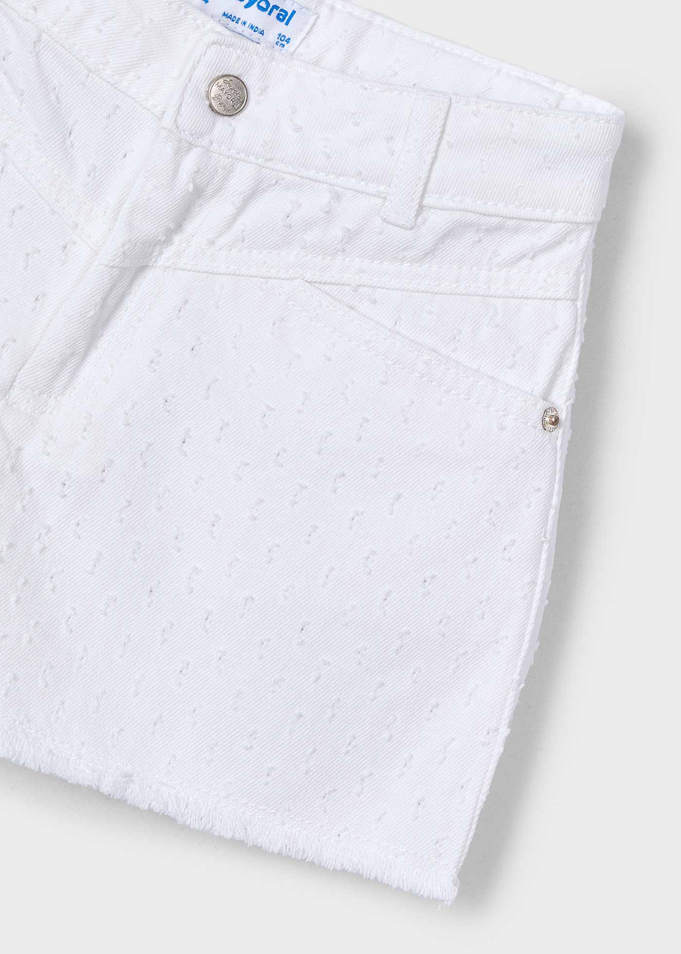 Pantalón corto bajo desflecado niña