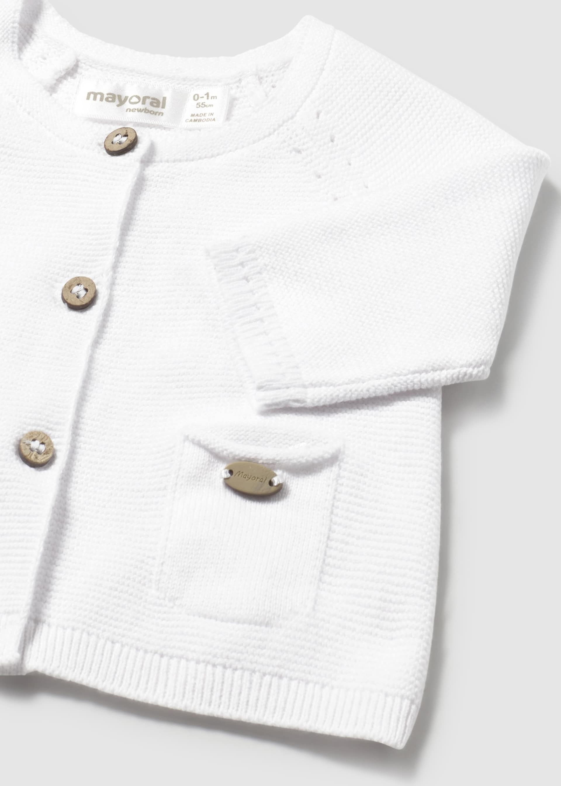 Трикотажна жилетка с копчета за новородено момиче Трикотажна жилетка с копчета за новородено момиче