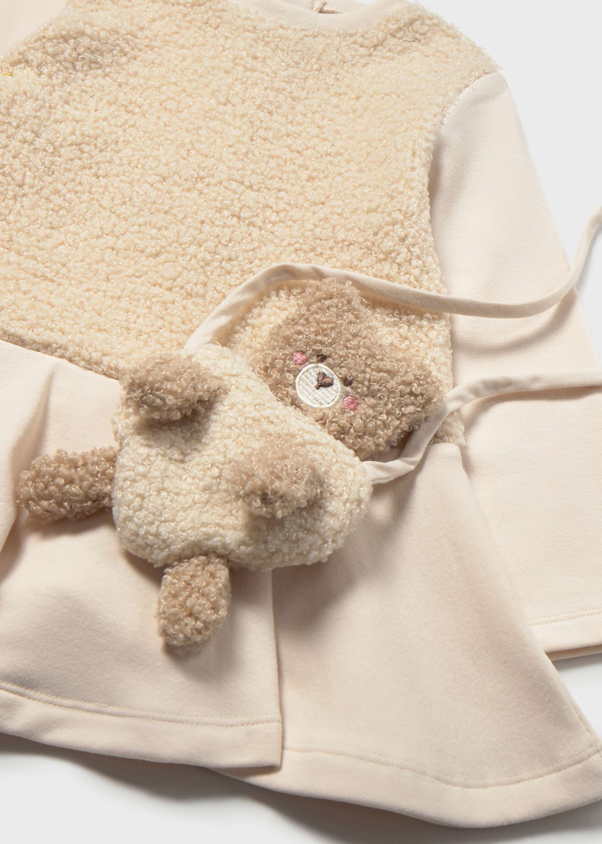 Dress paired with a baby bear handbag